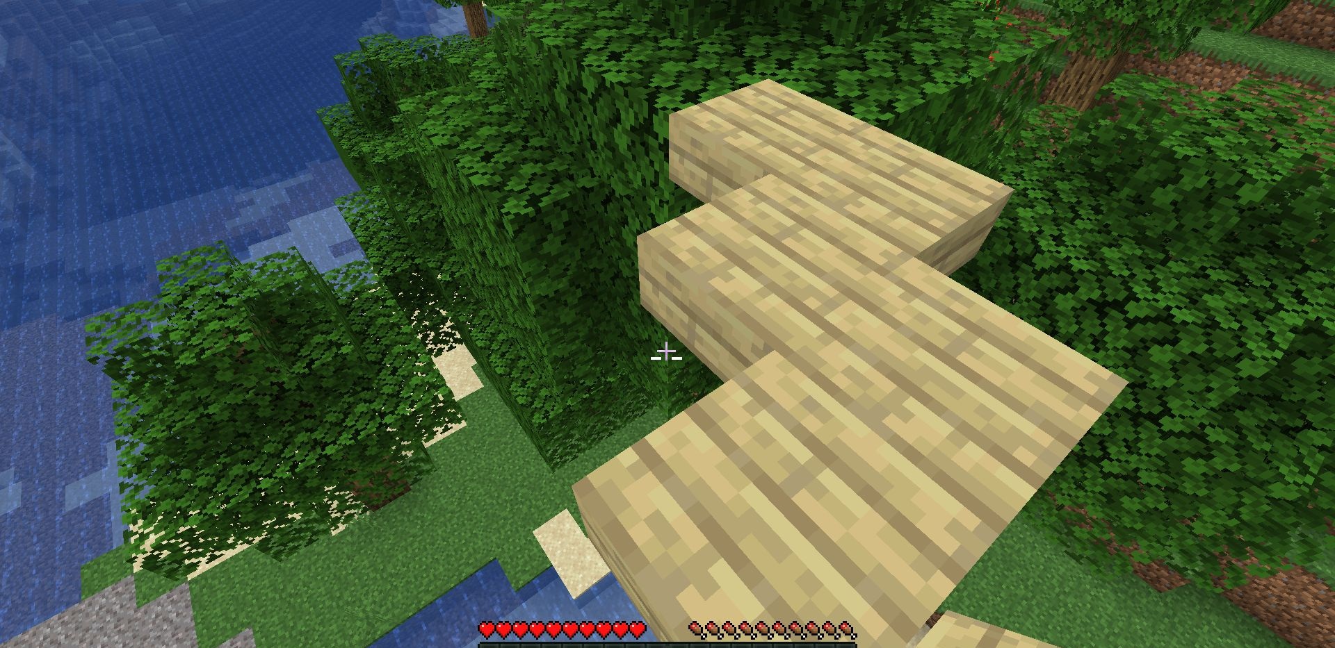 Игрок ставит блок под собой с помощью мода Reacharound в Minecraft