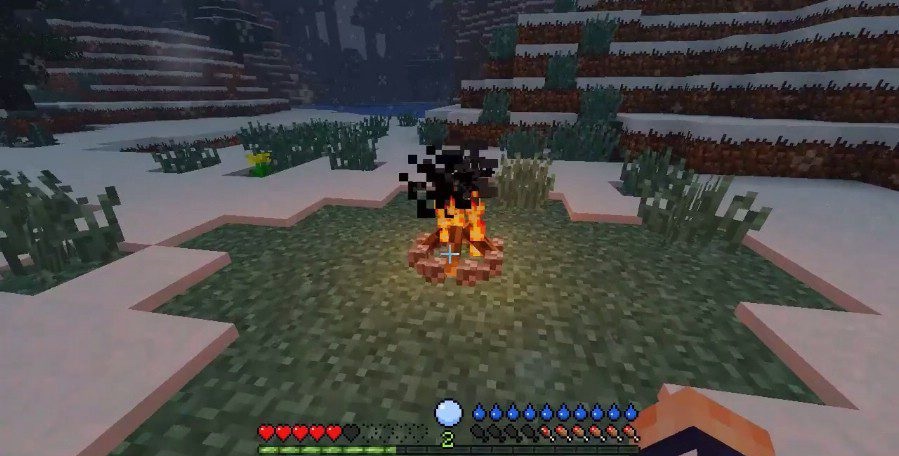 Игрок греется у костра в моде Tough As Nails для Minecraft